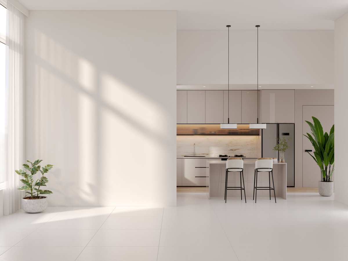 Bright open-plan interior with a modern kitchen island and empty wall
